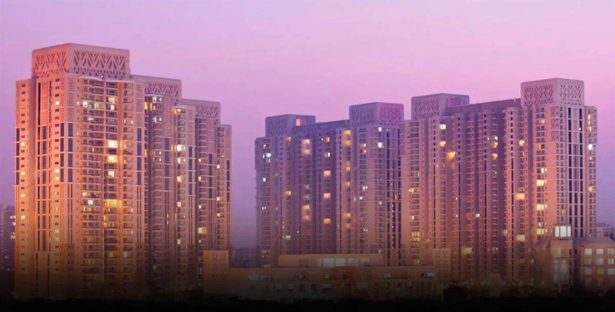 High-rise towers of DLF Park Place with lattice-patterned crowns at dusk, Sector 54, Golf Course Road, Gurugram